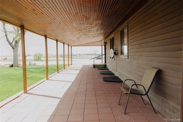 a view of a room with wooden floor and outdoor seating