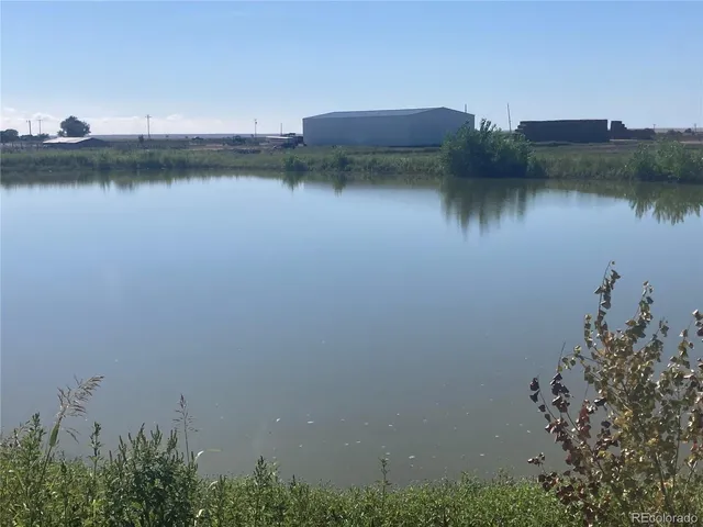 a view of a lake with a house in the background