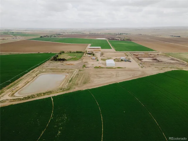 an aerial view of a house with a garden and lake view