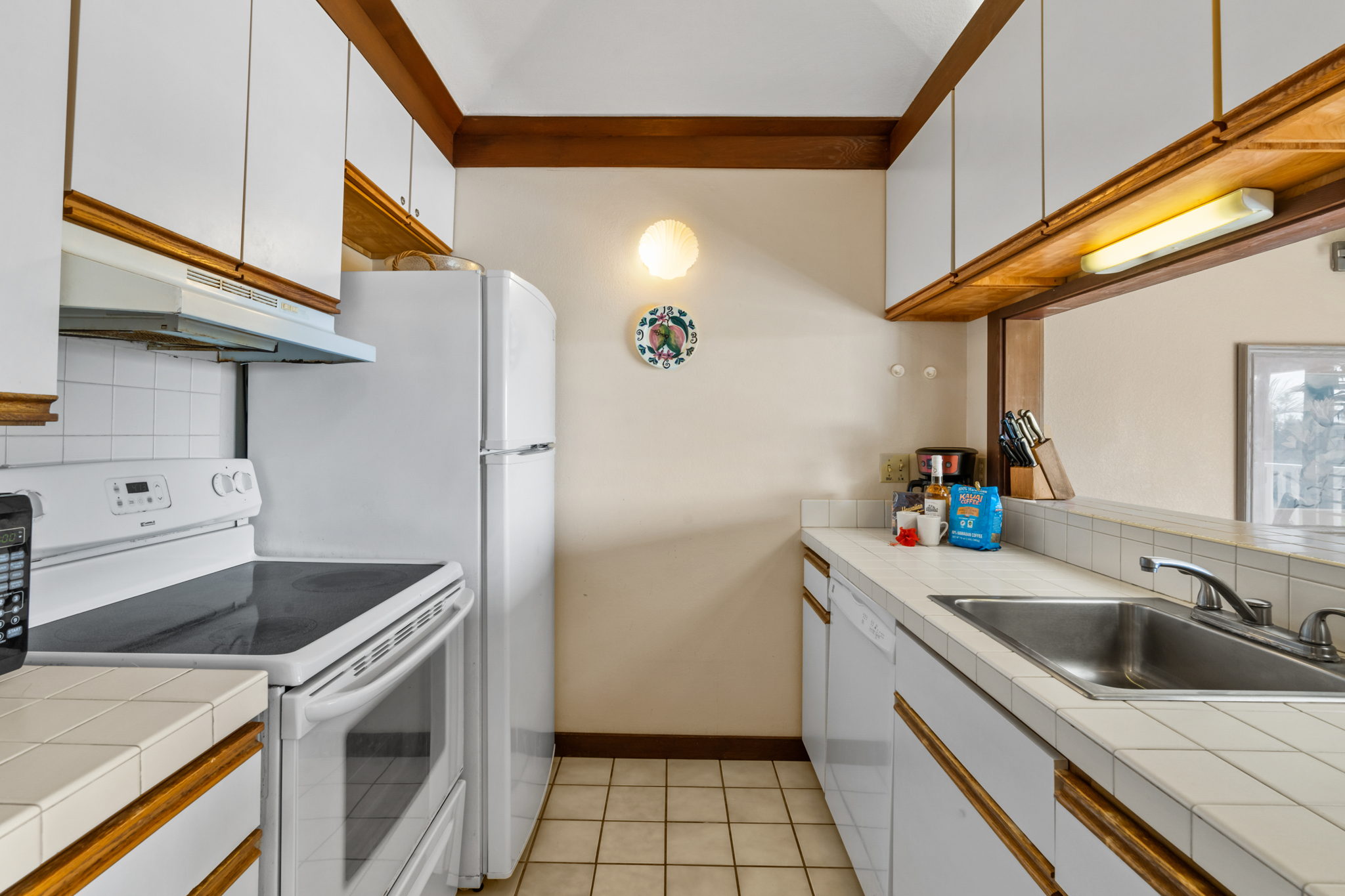 2253 Poipu Road, Unit 109 Koloa, HI 96756 - Photo 5 of 12 a kitchen that has a sink and a stove