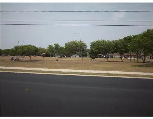 a view of a swimming pool and a yard