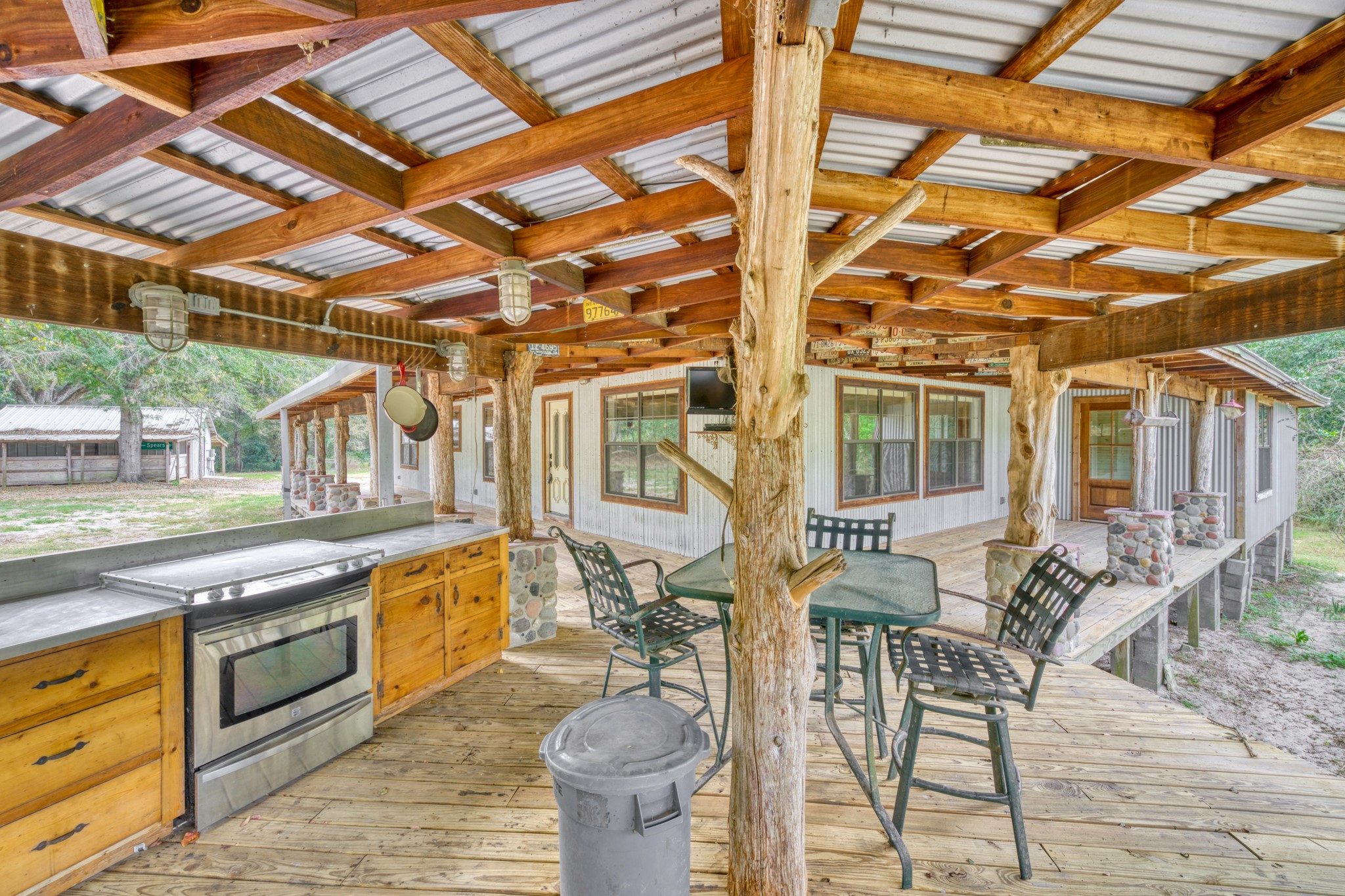 23405 Martha Williams Road Montgomery, TX 77356 - Photo 30 of 45 a view of a patio with dining table and chairs with wooden floor