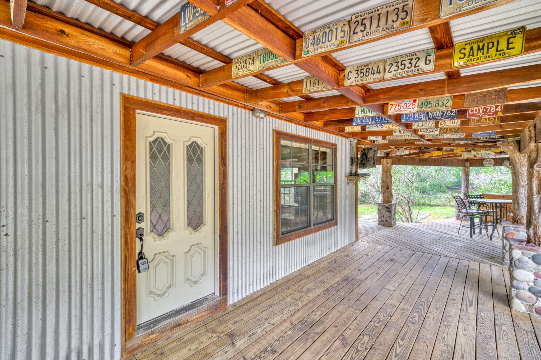 23405 Martha Williams Road Montgomery, TX 77356 - Photo 10 of 45 a view of a porch with wooden floor and iron stairs