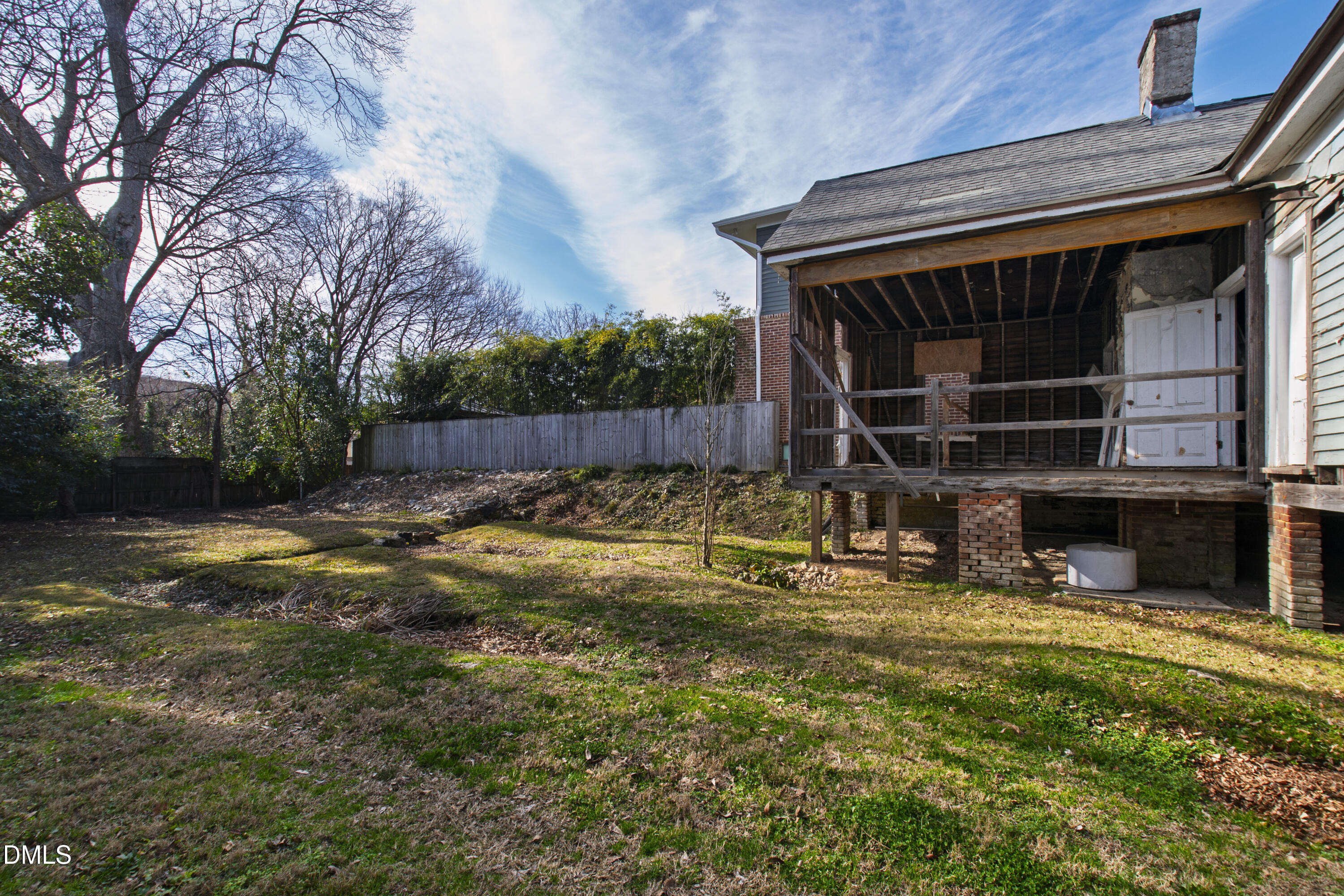 316 East Cabarrus Street Raleigh, NC 27601 - Photo 15 of 20 a view of backyard with wooden fence and a large tree