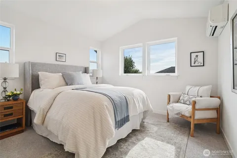 a bedroom with a bed and a couch