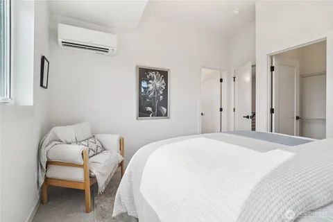 a bedroom with a bed and a chair