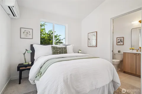 a bed sitting in a bedroom next to a window