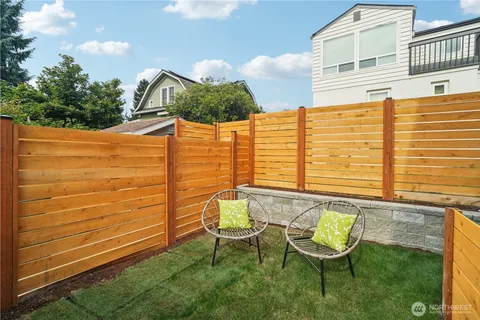 a view of a chairs and table in backyard