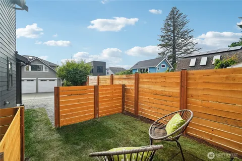 a view of a chair and table in the backyard