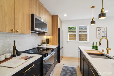 a kitchen that has a sink and a stove in it