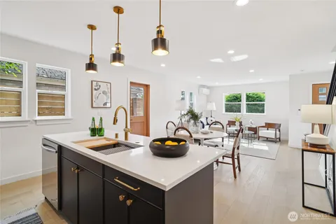 a kitchen with a sink a counter and chairs
