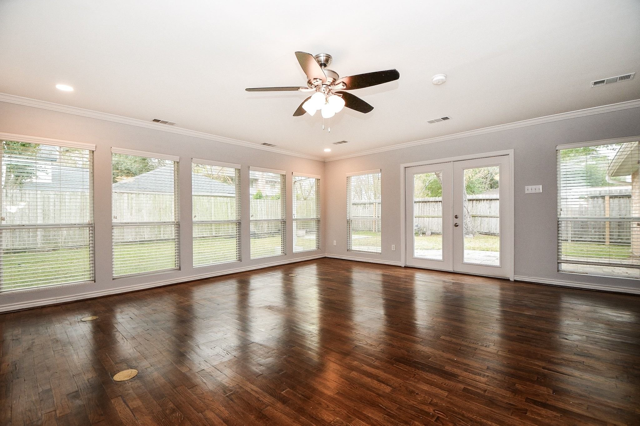 14011 Wickersham Lane Houston, TX 77077 - Photo 14 of 38 Walls of windows and stunning hardwood floors make this sunroom a true standout, all overlooking the private backyard.