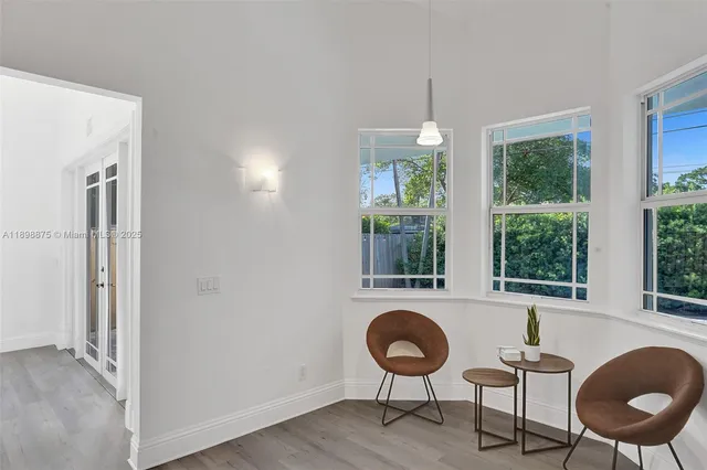 a spacious bedroom with two beds and a window