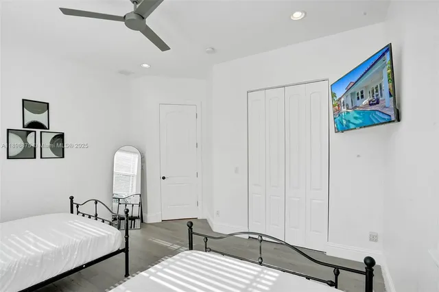 a bedroom with a bed and a painting on the wall