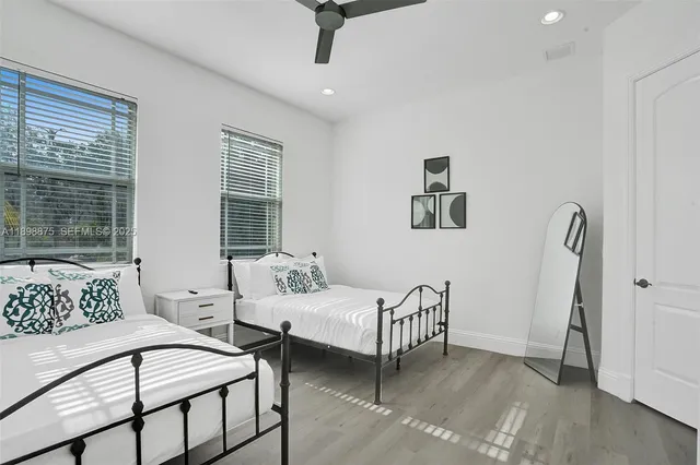 a bedroom with a bed and a painting on the wall