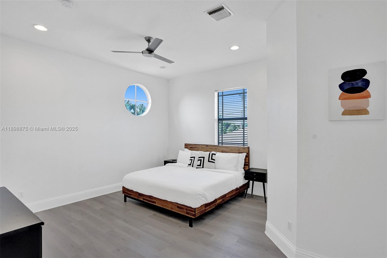 1207 Southwest 21st Street Fort Lauderdale, FL 33315 - Photo 32 of 81 a bedroom with a bed and a wall painting