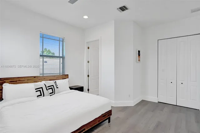 a bedroom with a bed and window