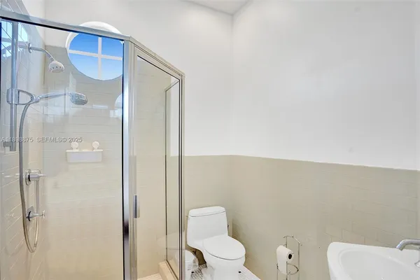 a bathroom with a sink a toilet and a mirror