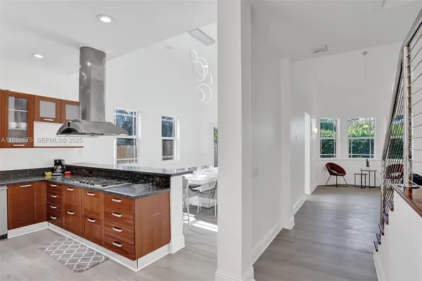 a kitchen with stainless steel appliances granite countertop a sink a stove and a microwave oven