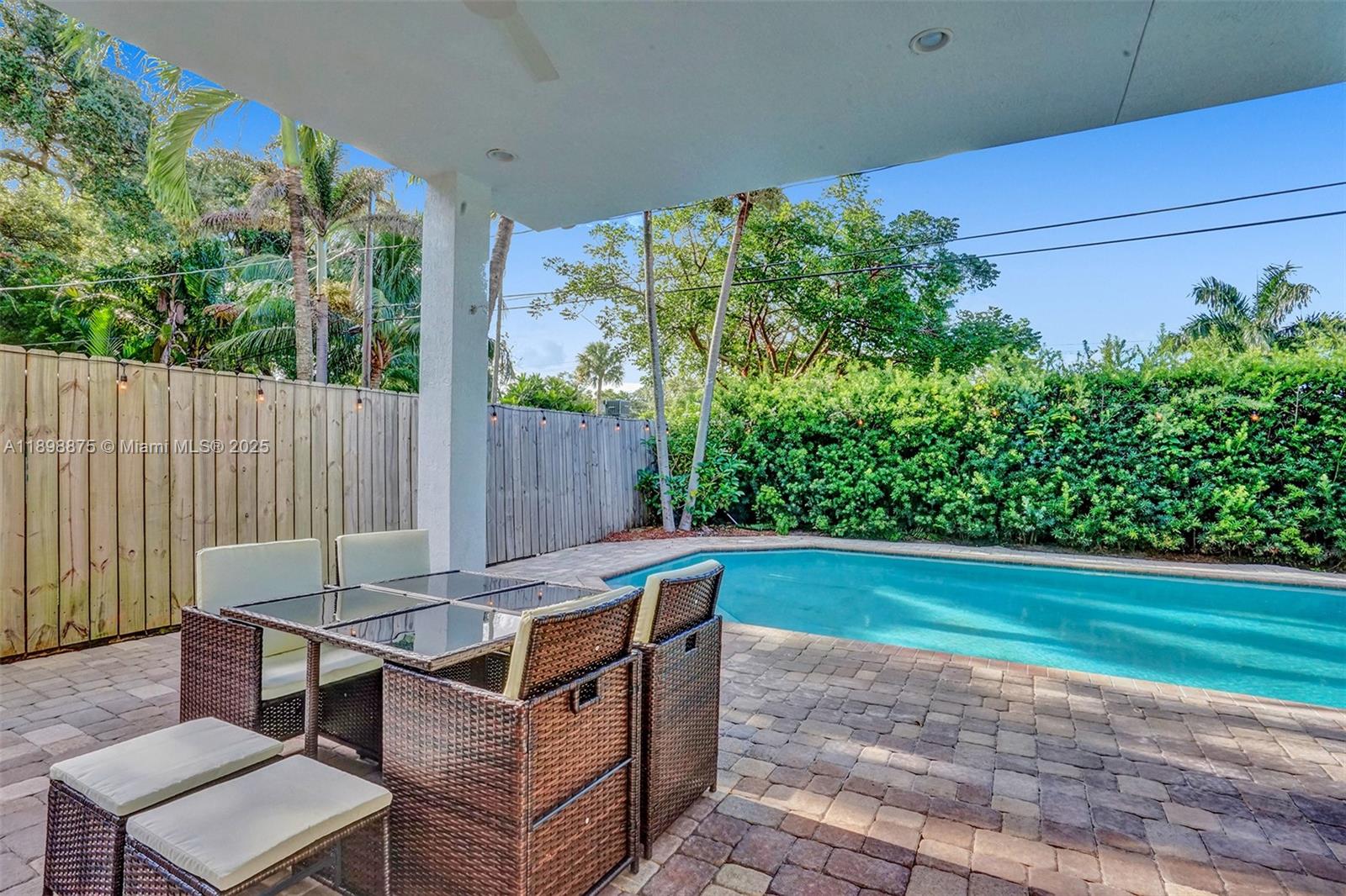 1207 Southwest 21st Street Fort Lauderdale, FL 33315 - Photo 63 of 81 a backyard of a house with yard table and chairs