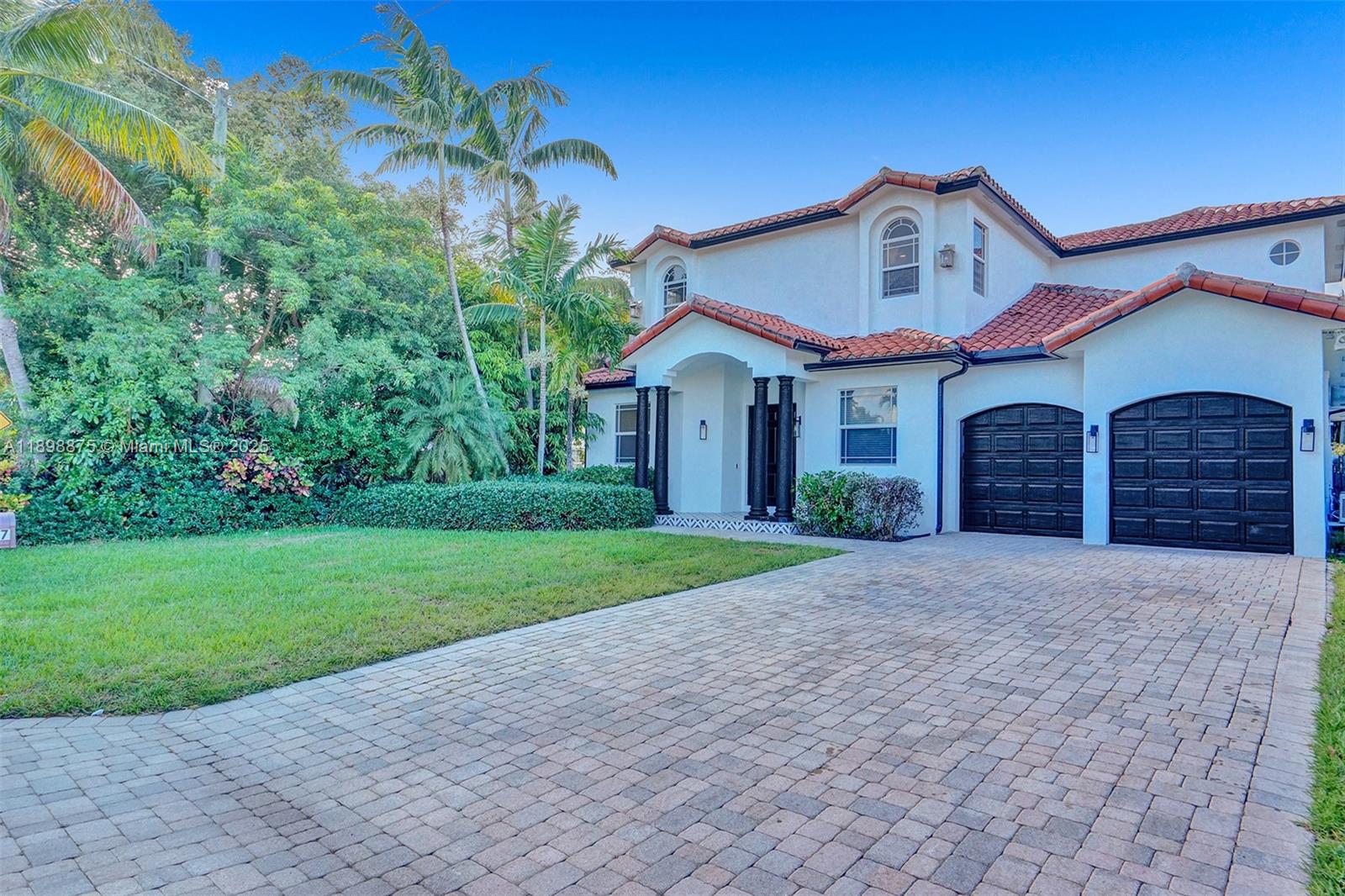 1207 Southwest 21st Street Fort Lauderdale, FL 33315 - Photo 80 of 81 a front view of a house with a yard and garage