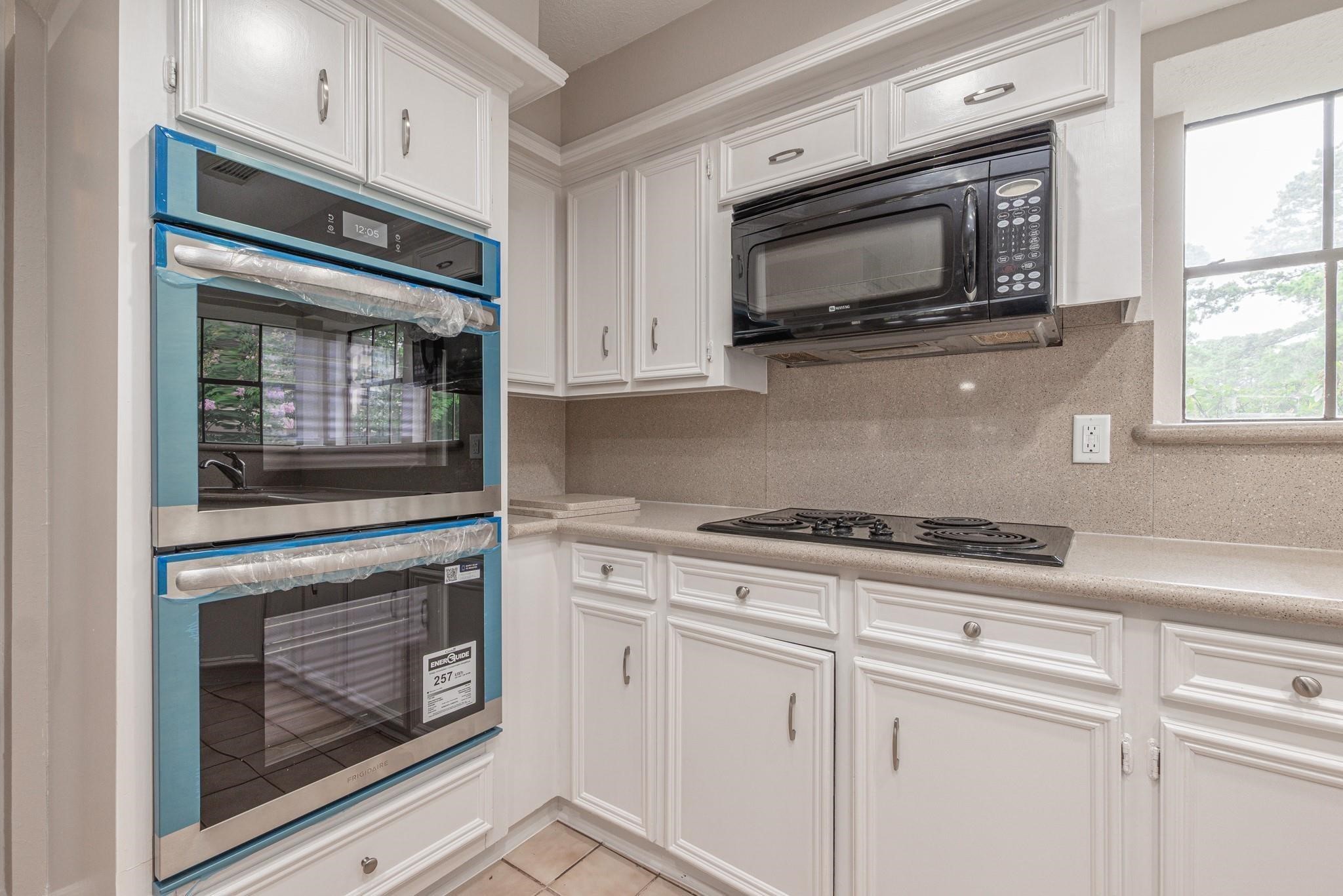 8019 Beaufort Drive Spring, TX 77379 - Photo 3 of 47 a kitchen with granite countertop white cabinets stainless steel appliances and sink