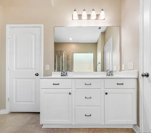 a bathroom with a sink vanity and mirror