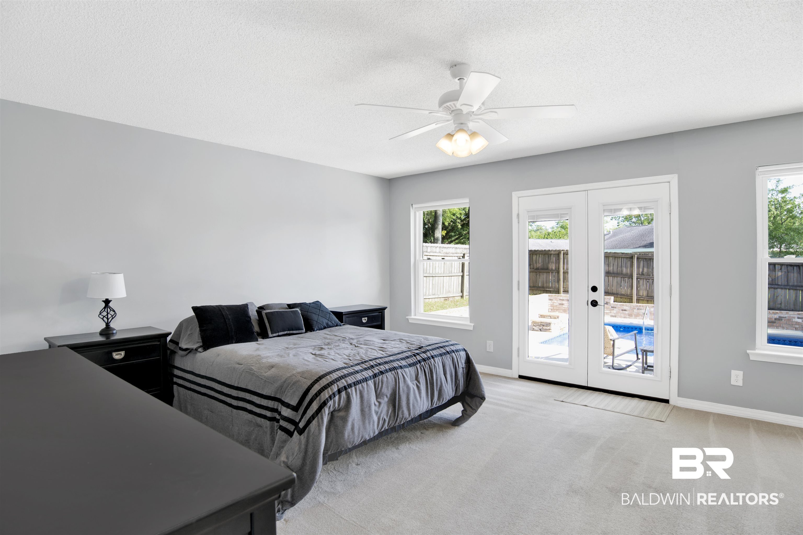 7431 Summer Court Mobile, AL 36695 - Photo 25 of 37 Bedroom with access to outside, french doors, light carpet, baseboards, and a textured ceiling