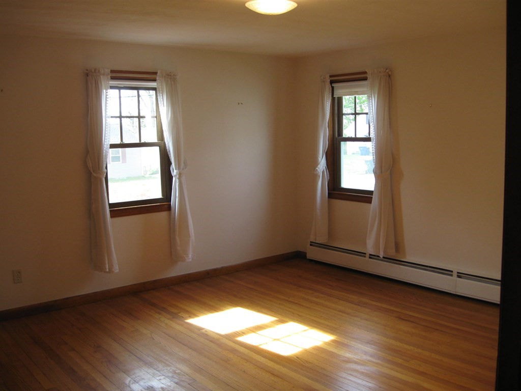 269 West Allen Ridge Road Springfield, MA 01118 - Photo 14 of 25 an empty room with wooden floor and windows
