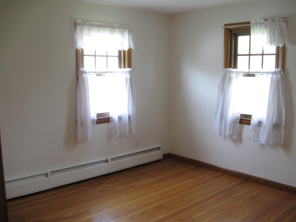 269 West Allen Ridge Road Springfield, MA 01118 - Photo 16 of 25 an empty room with wooden floor and windows