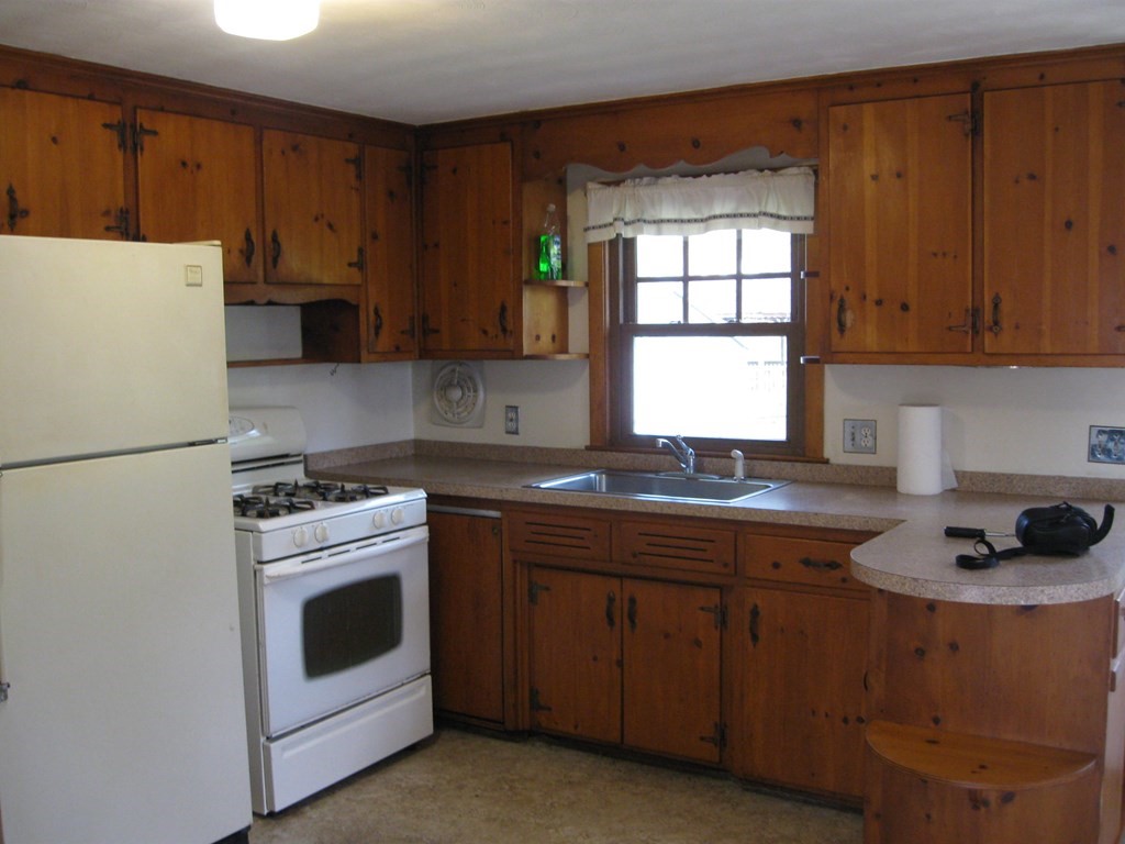 269 West Allen Ridge Road Springfield, MA 01118 - Photo 9 of 25 a kitchen with a white stove top oven and refrigerator