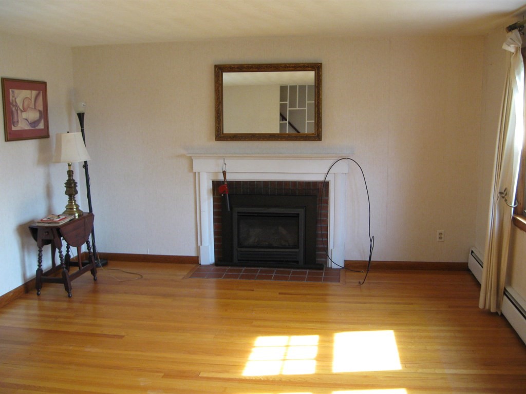 269 West Allen Ridge Road Springfield, MA 01118 - Photo 10 of 25 a view of a livingroom with a fireplace and window
