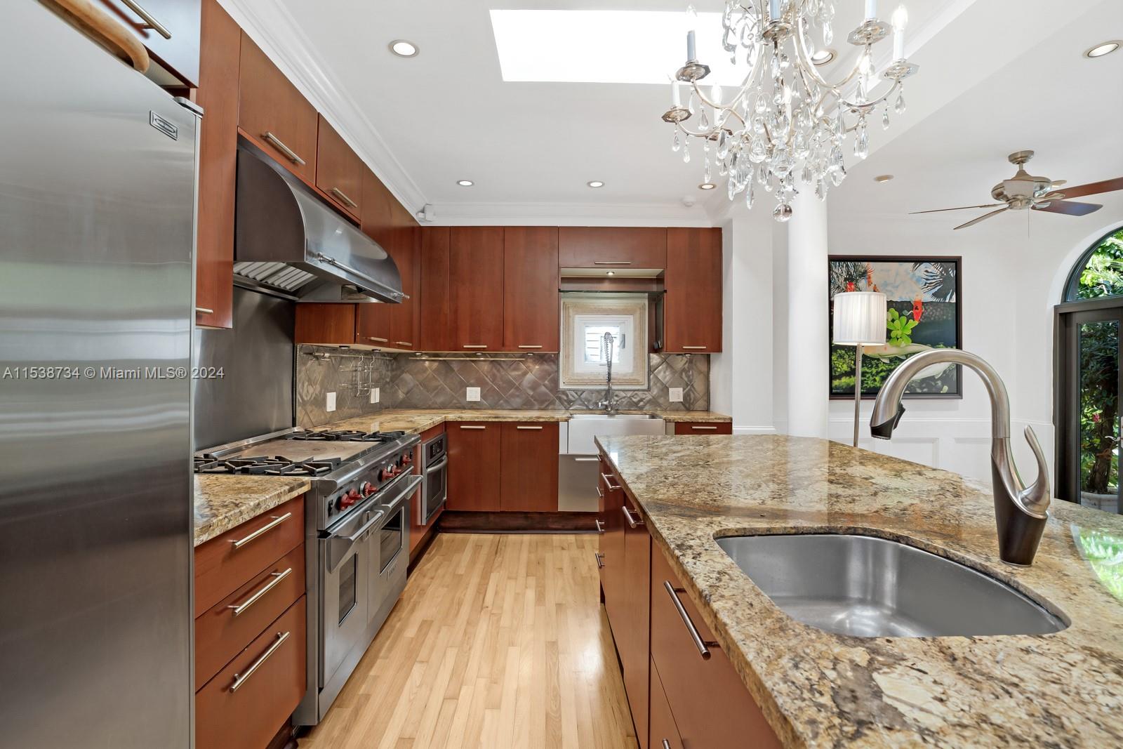 3685 Royal Palm Avenue Miami, FL 33133 - Photo 12 of 41 a kitchen with stainless steel appliances granite countertop a sink stove and refrigerator