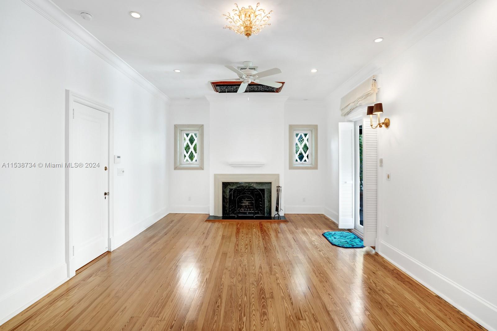 3685 Royal Palm Avenue Miami, FL 33133 - Photo 16 of 41 a view of a livingroom with a fireplace and window