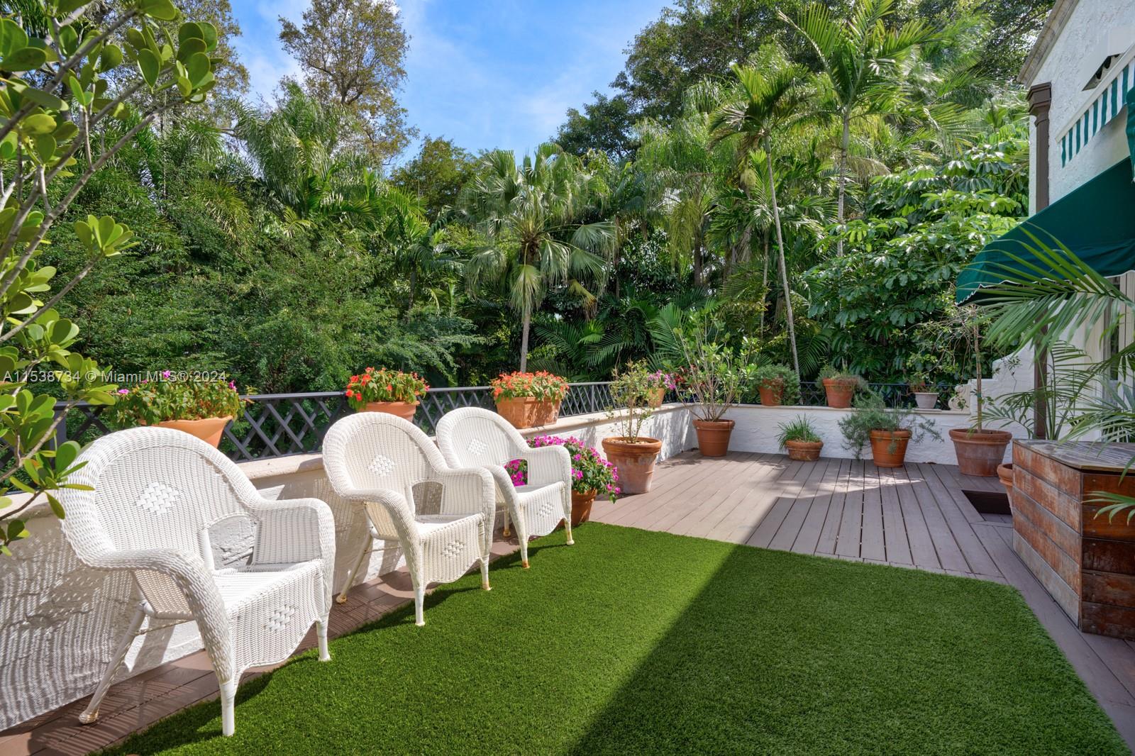 3685 Royal Palm Avenue Miami, FL 33133 - Photo 18 of 41 a view of a patio with table and chairs with wooden floor and fence