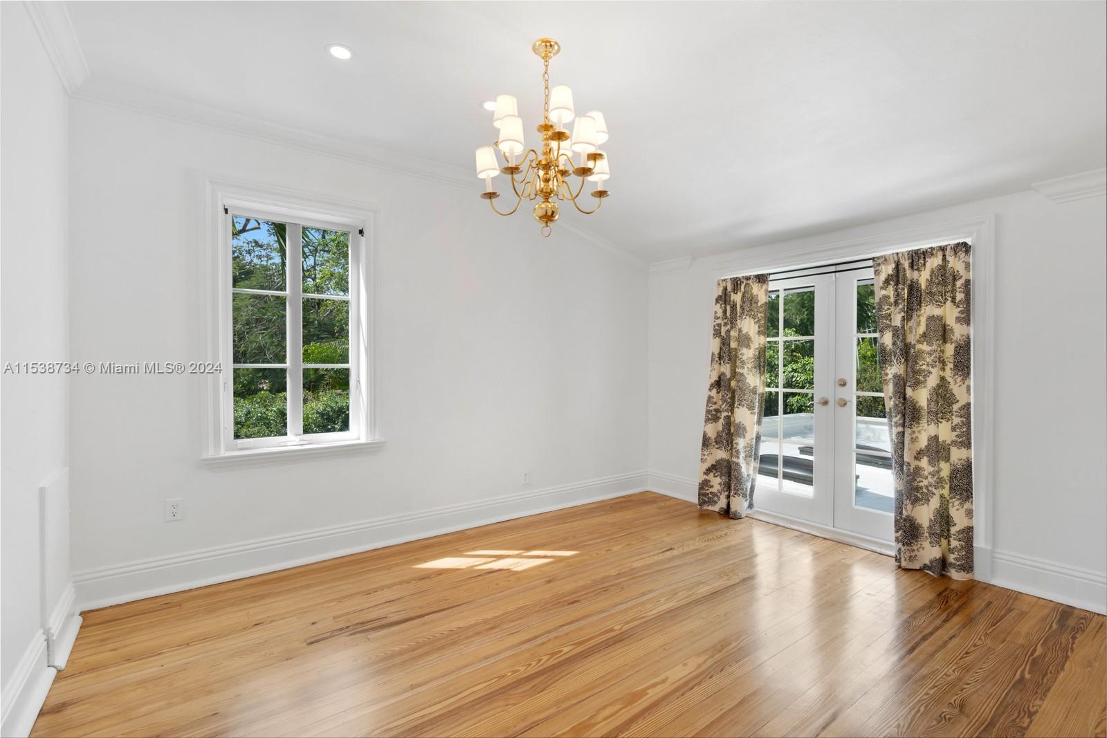 3685 Royal Palm Avenue Miami, FL 33133 - Photo 20 of 41 wooden floor in an empty room with a window