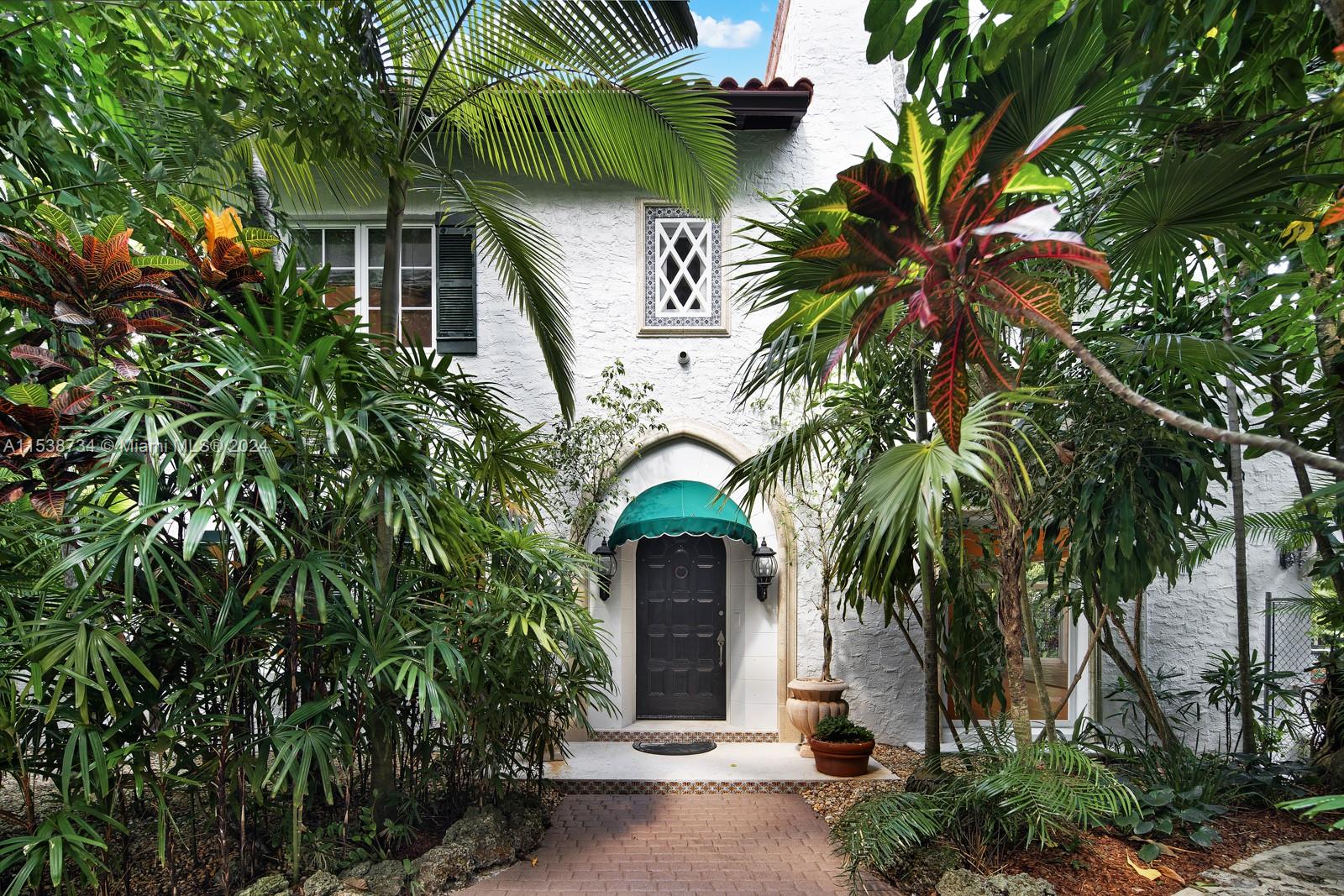 3685 Royal Palm Avenue Miami, FL 33133 - Photo 2 of 41 a front view of a house with a garden