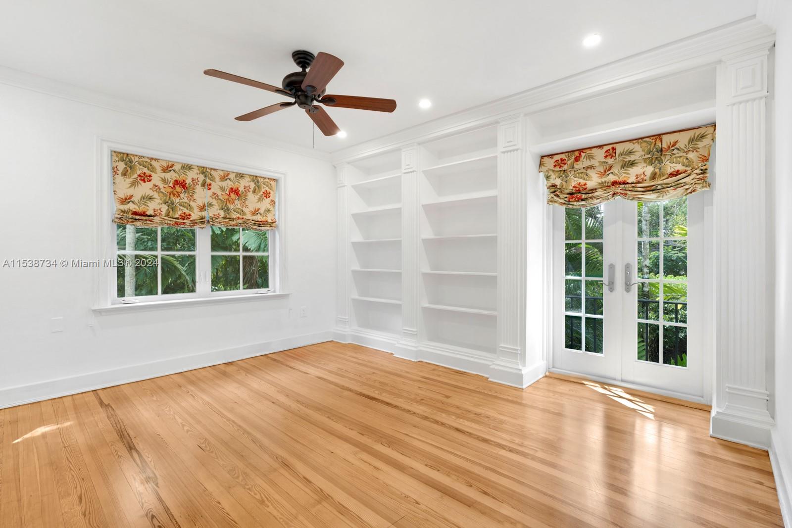 3685 Royal Palm Avenue Miami, FL 33133 - Photo 22 of 41 a view of empty room with wooden floor and fan