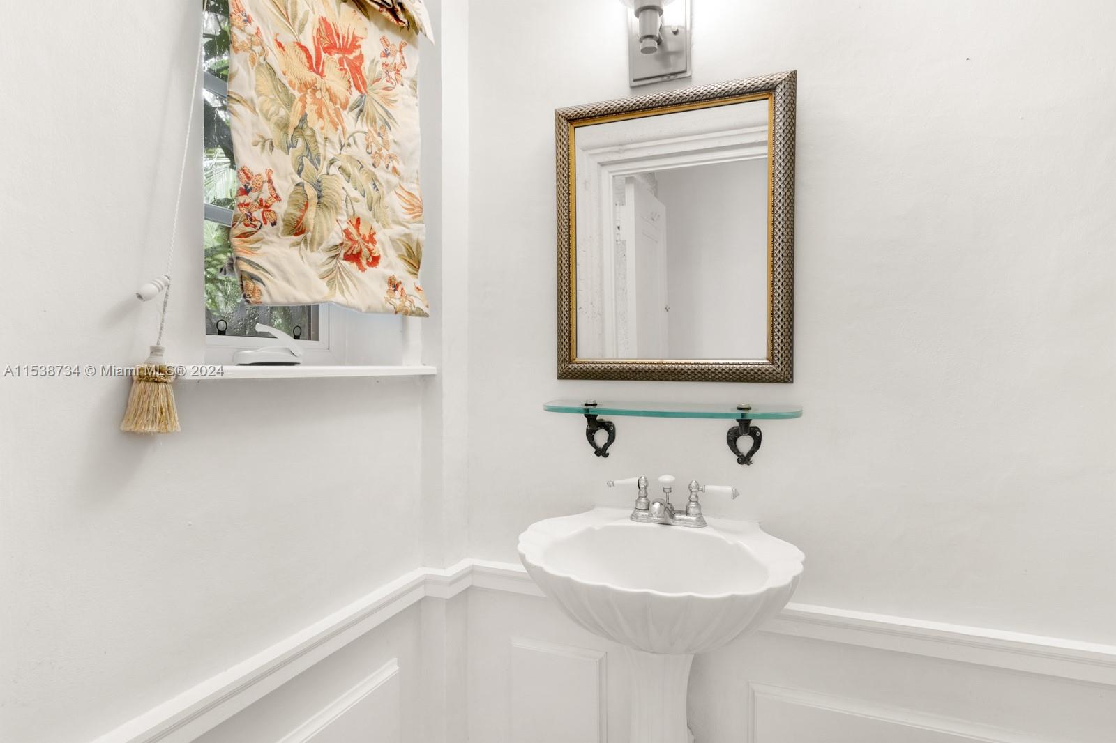 3685 Royal Palm Avenue Miami, FL 33133 - Photo 23 of 41 a bathroom with a sink and a mirror