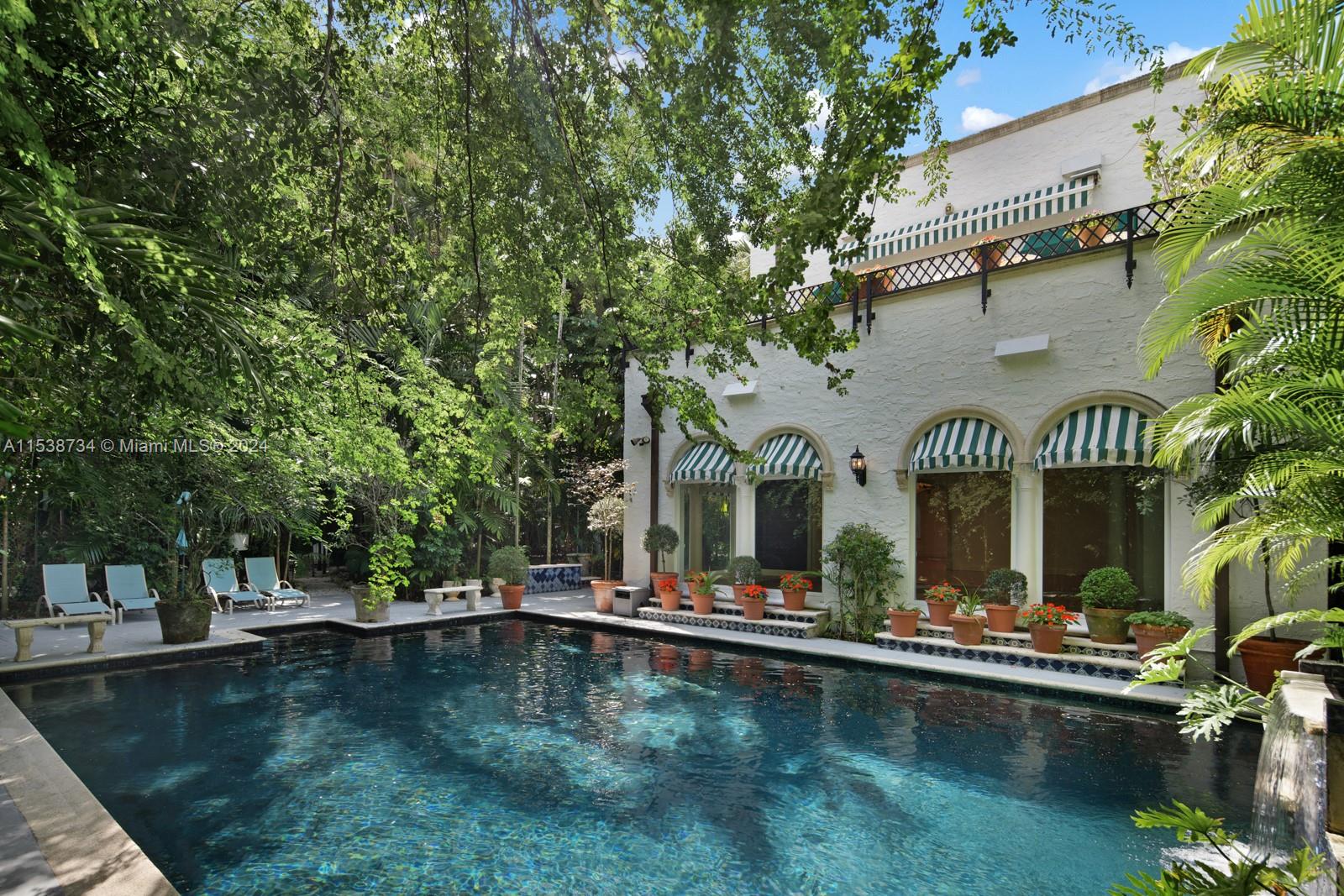 3685 Royal Palm Avenue Miami, FL 33133 - Photo 25 of 41 a view of swimming pool with outdoor seating and a garden