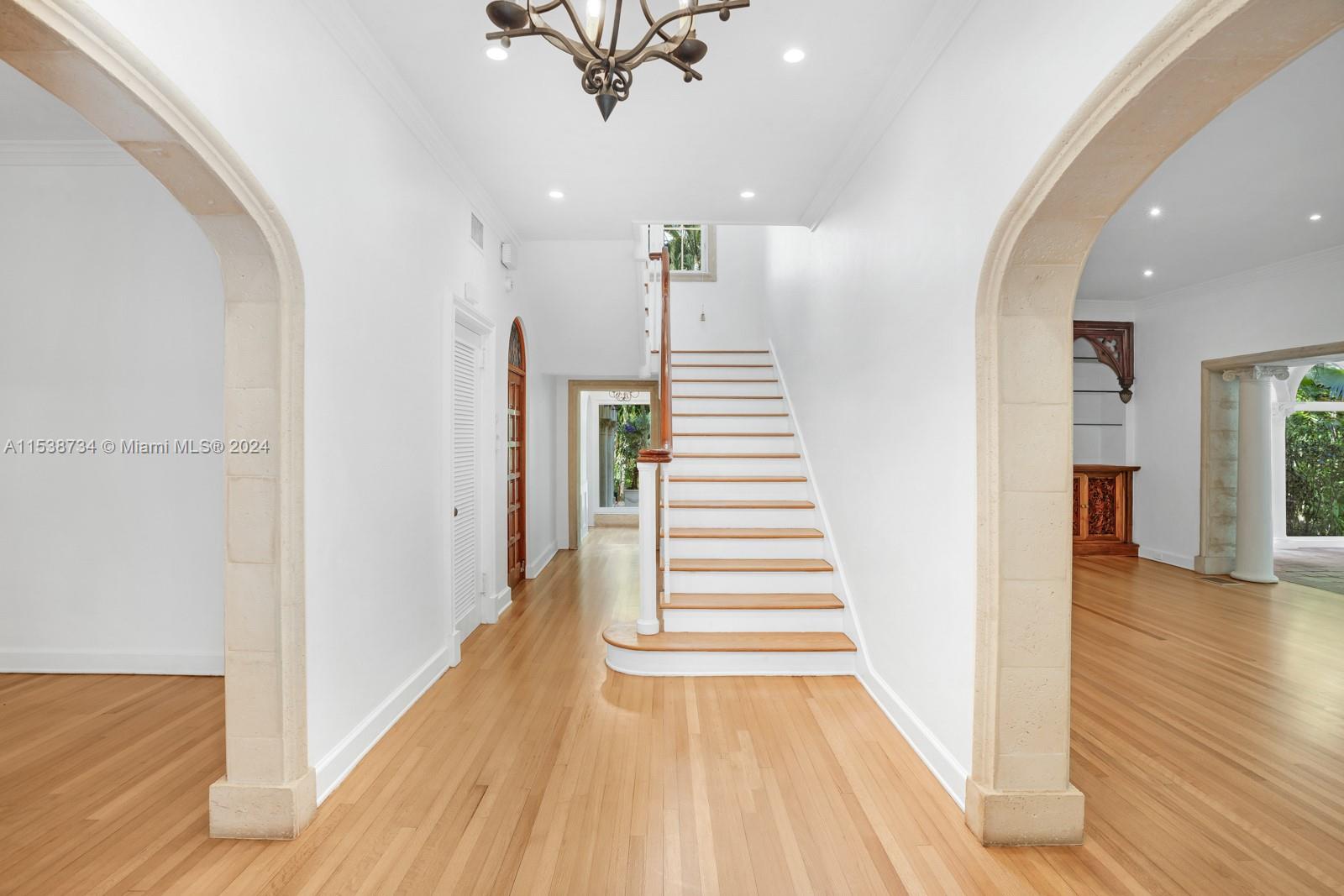 3685 Royal Palm Avenue Miami, FL 33133 - Photo 3 of 41 a view of a hallway with wooden floor and stairs