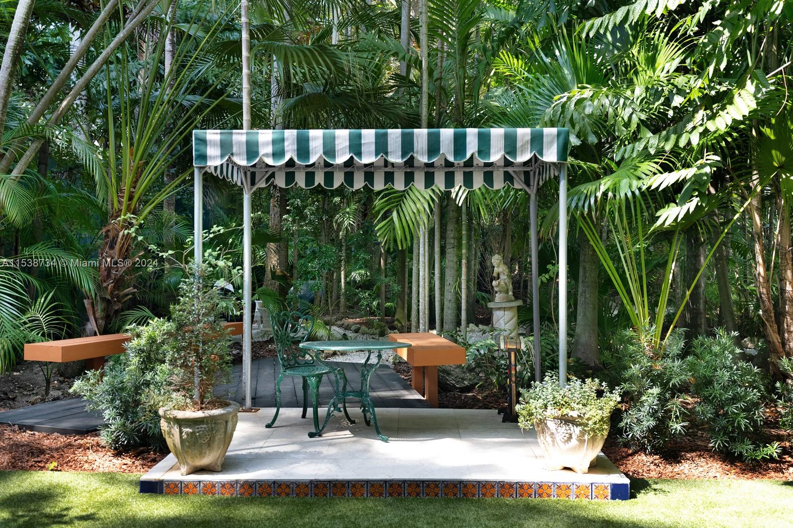 3685 Royal Palm Avenue Miami, FL 33133 - Photo 31 of 41 a view of a chair and tables in backyard of a house
