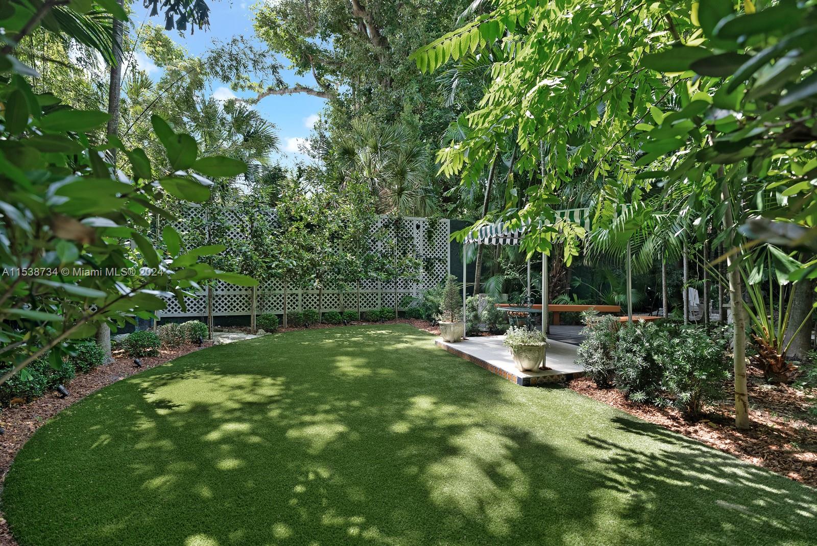 3685 Royal Palm Avenue Miami, FL 33133 - Photo 32 of 41 a view of backyard with a table and chairs