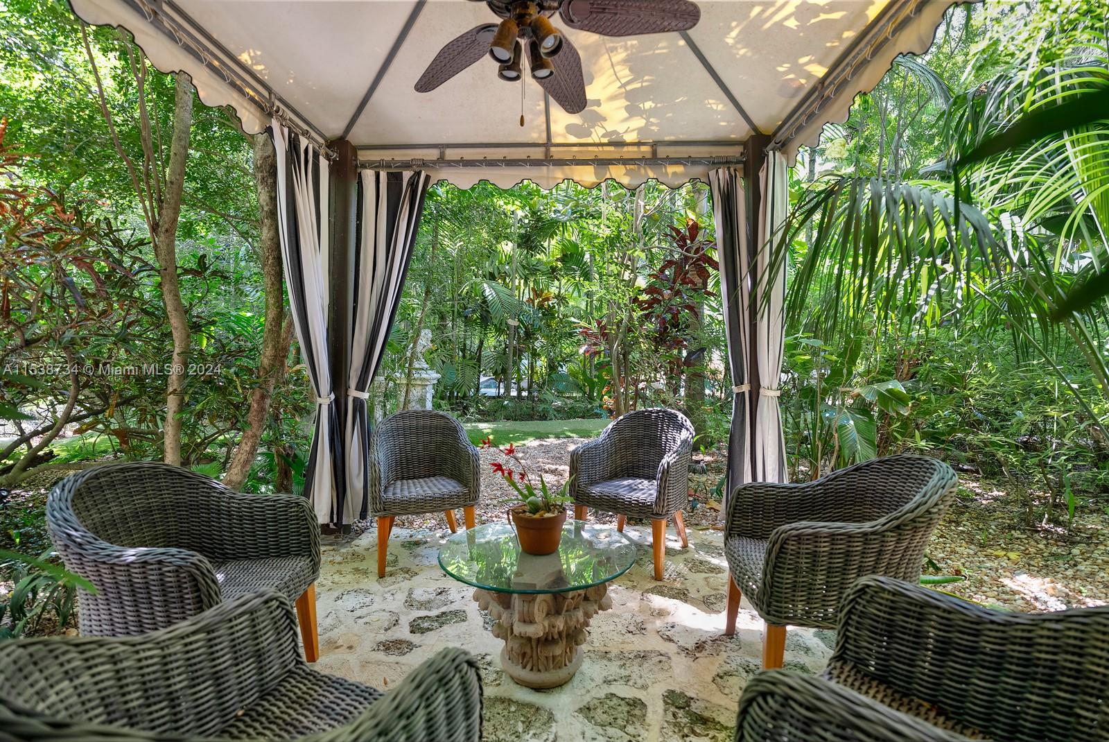 3685 Royal Palm Avenue Miami, FL 33133 - Photo 34 of 41 a front view of a house with garden and patio