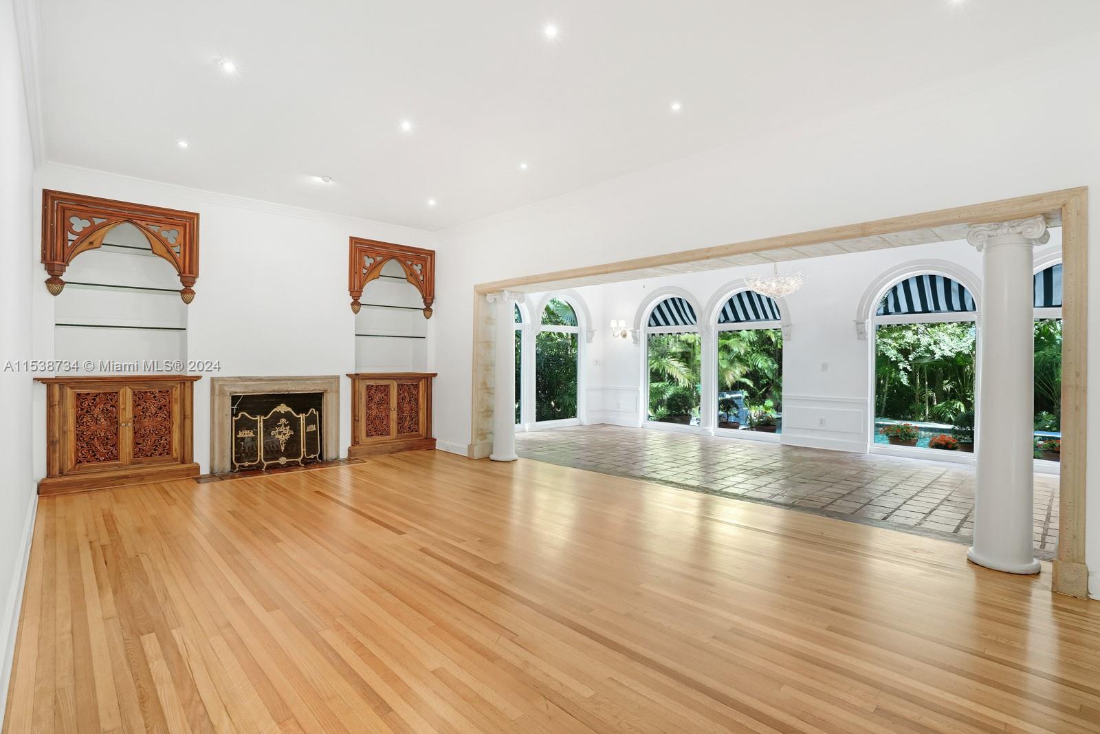 3685 Royal Palm Avenue Miami, FL 33133 - Photo 4 of 41 a view of an empty room with wooden floor and a window