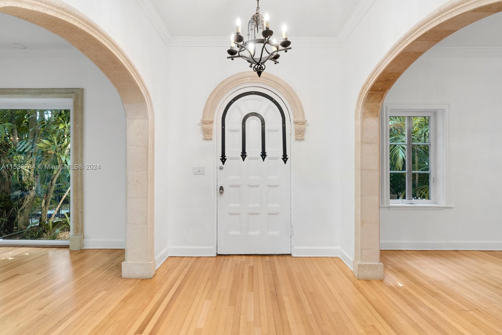 3685 Royal Palm Avenue Miami, FL 33133 - Photo 8 of 41 a view of empty room with window and wooden floor