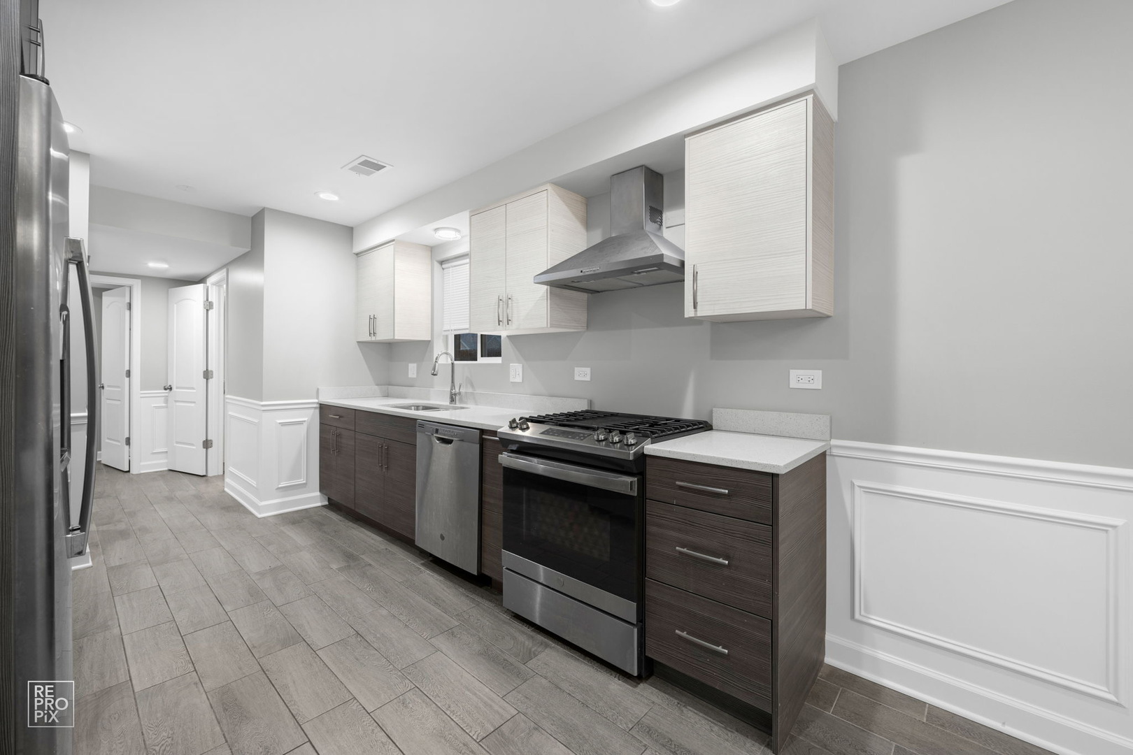 3707 139th Place Robbins, IL 60472 - Photo 4 of 27 a kitchen with stainless steel appliances granite countertop a sink a stove and a refrigerator