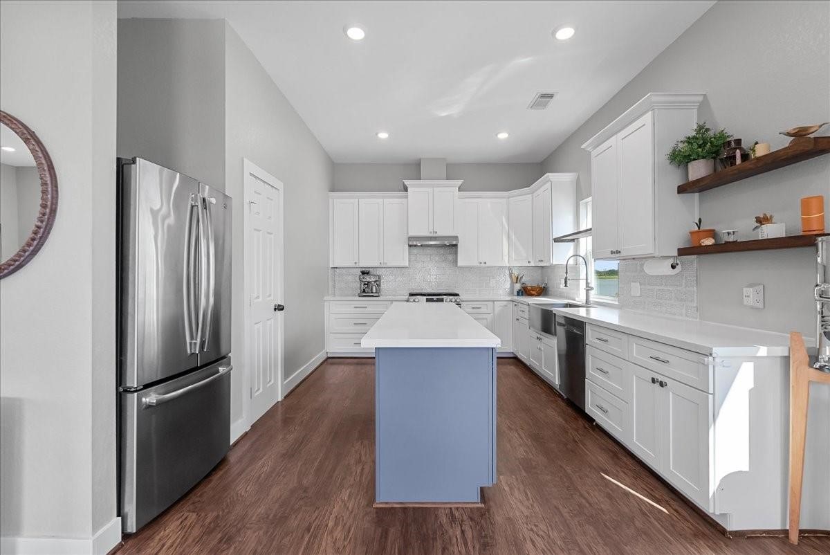 1205 Todville Road Seabrook, TX 77586 - Photo 14 of 37 a large kitchen with stainless steel appliances sink a microwave and cabinets