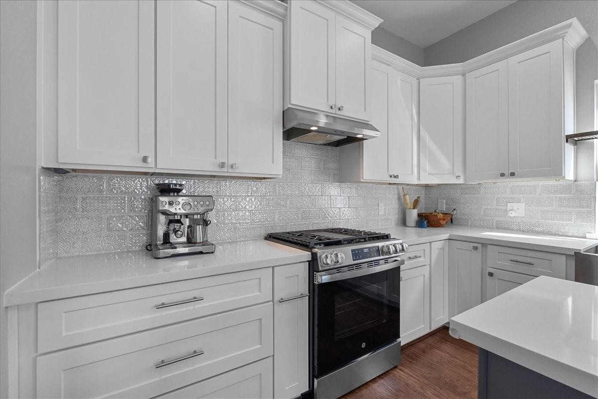 1205 Todville Road Seabrook, TX 77586 - Photo 15 of 37 a kitchen with granite countertop white cabinets and stainless steel appliances