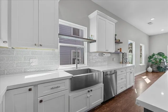 a kitchen with stainless steel appliances granite countertop a sink stove and cabinets